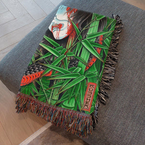 Snake and Namakubi Blanket draped over sofa for edgy home decor