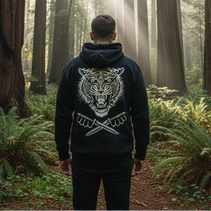 Person wearing a hoodie with a tiger design in a forest