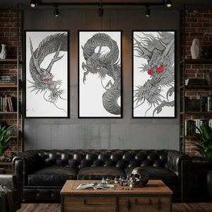 Three dragon artworks on a wall above a leather sofa in a room with brick walls and a wooden coffee table.