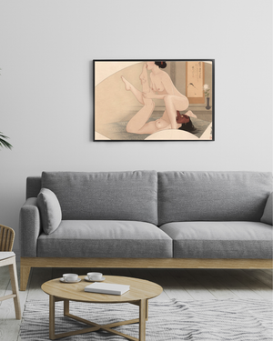 Living room with a gray sofa, round wooden coffee table, and a framed artwork on the wall.