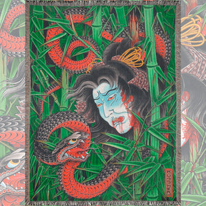 Ryan Ussher Kaze No Yusha Blanket displayed on bed, woven cotton throw.