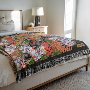 The Snake and The Namakubi Blanket draped over a couch for artistic home decor