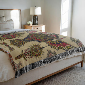 Eternal Suffering Blanket draped over a sofa, showcasing its bold design.