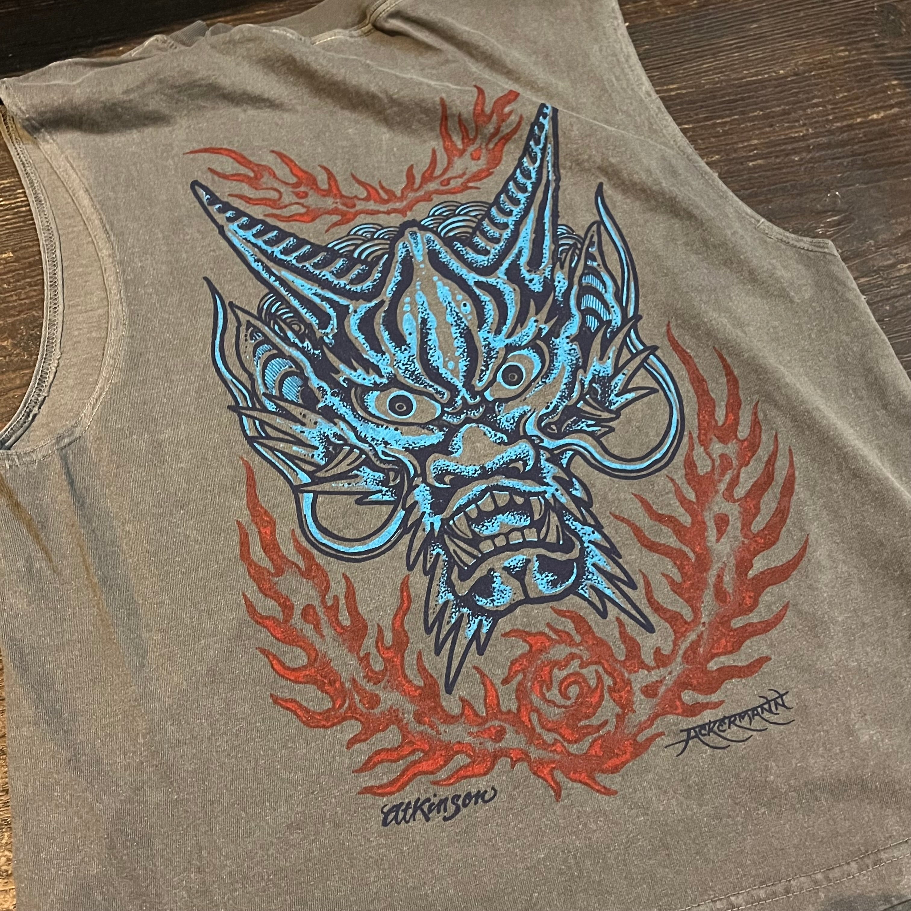 Tank top with a dragon design on a wooden surface