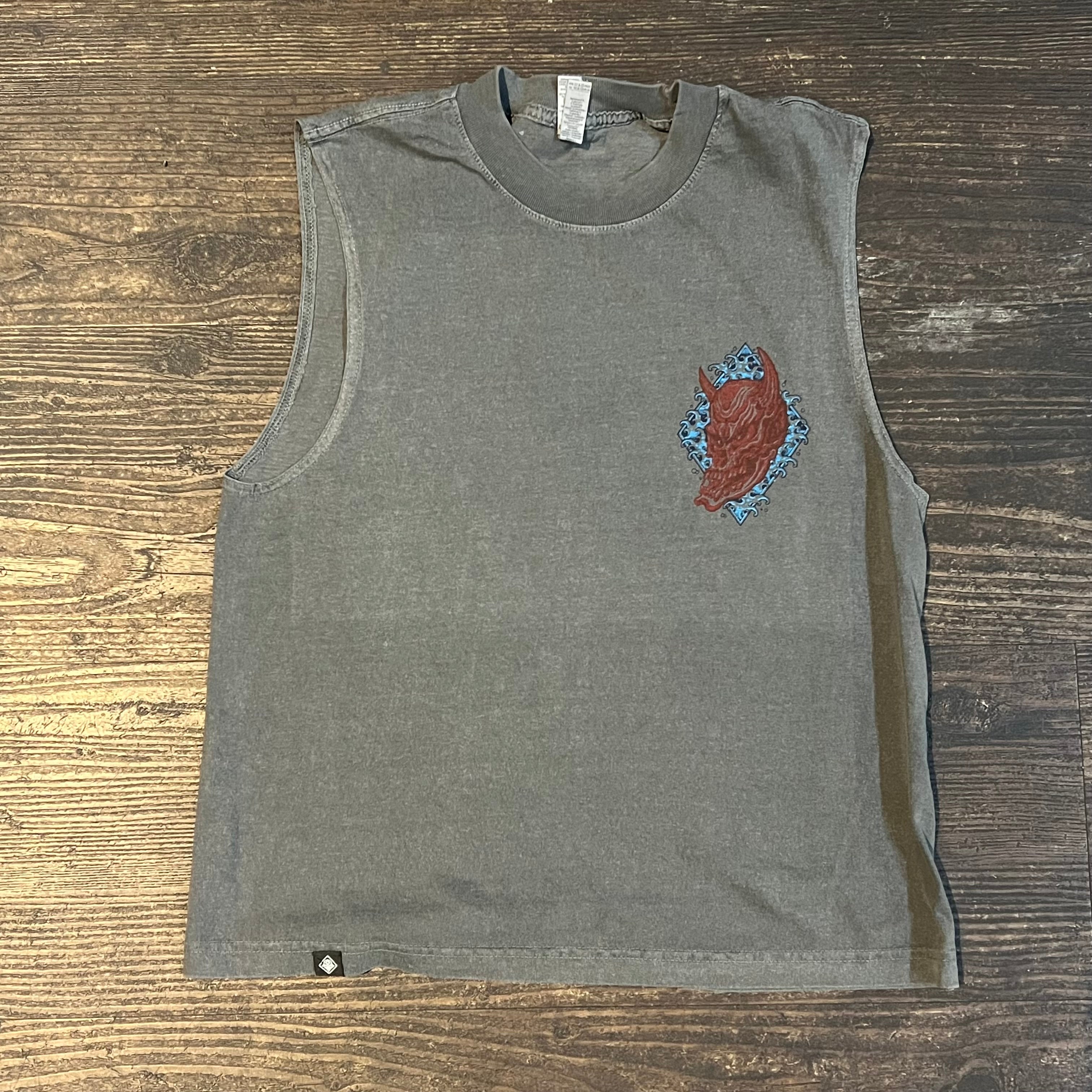 Gray sleeveless shirt with a colorful design on a wooden surface