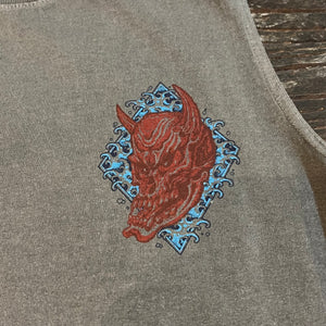 Embroidered design on a gray fabric with a red and blue pattern