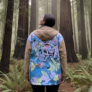 Person wearing a colorful jacket with a skull design in a forest setting
