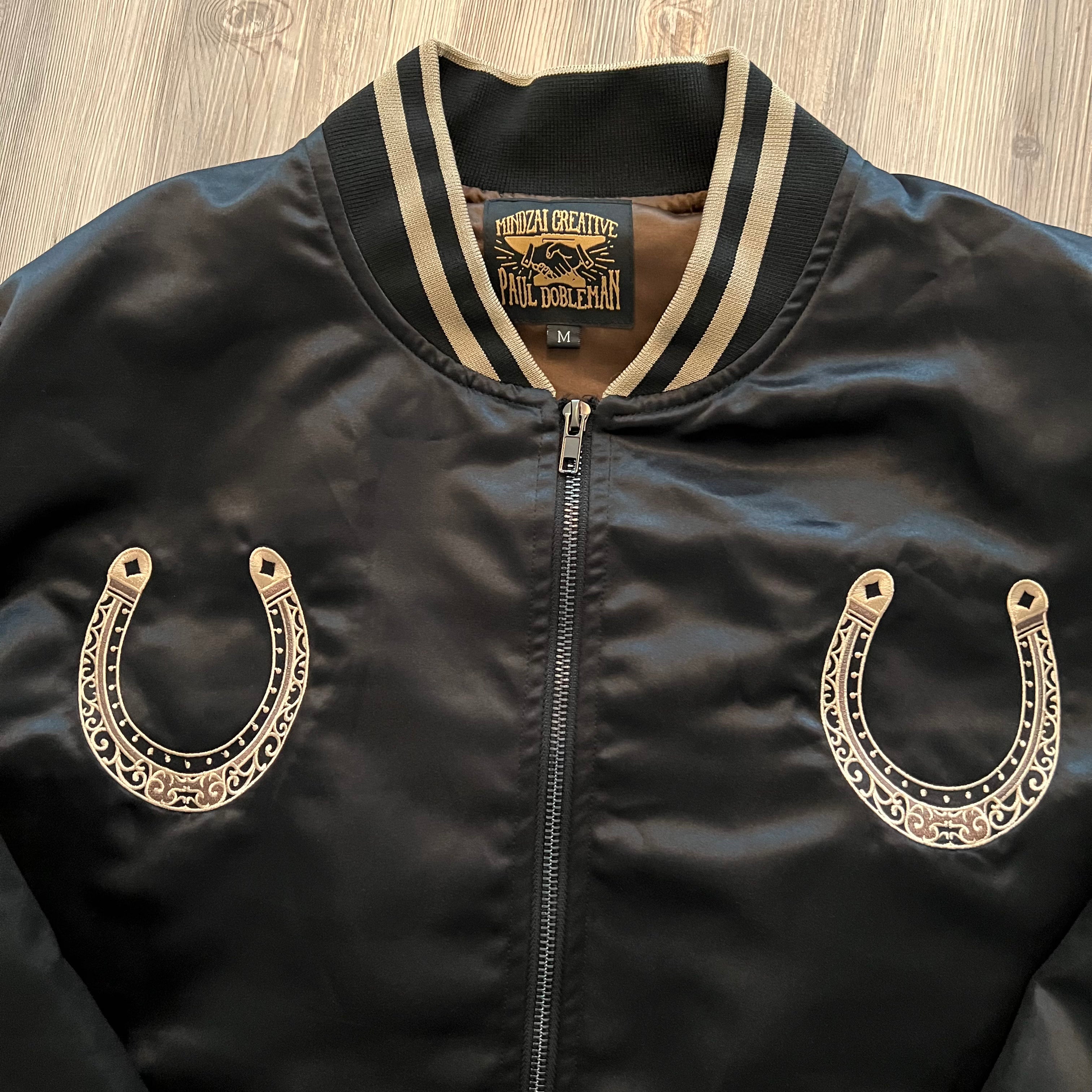 Packaging view of the satin bomber jacket folded inside branded Mindzai box.