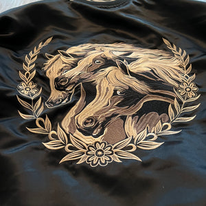 Detail of embroidered motif on chest of Year of the Horse satin bomber jacket.