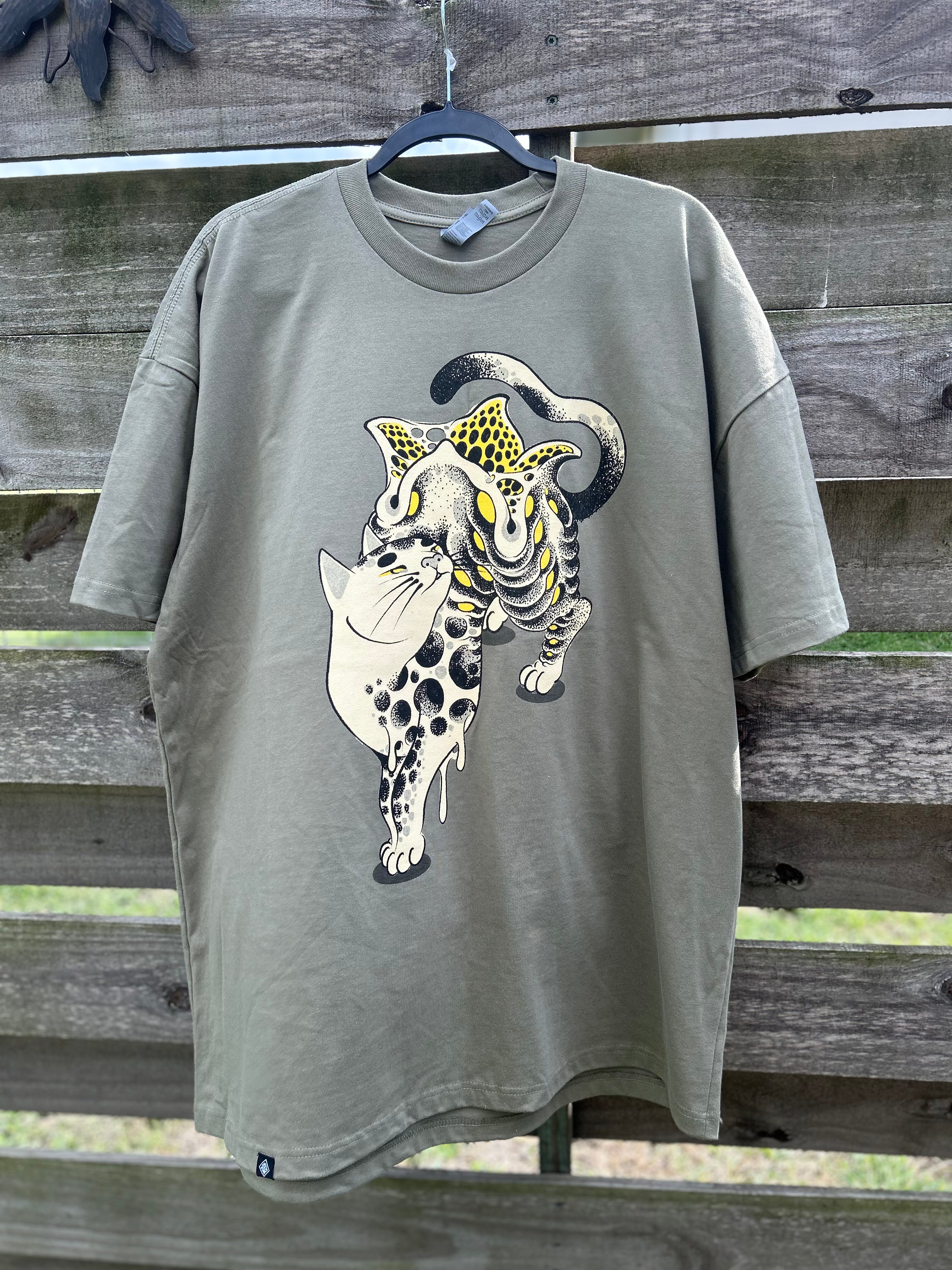 Gray t-shirt with a graphic design of a leopard on a wooden background