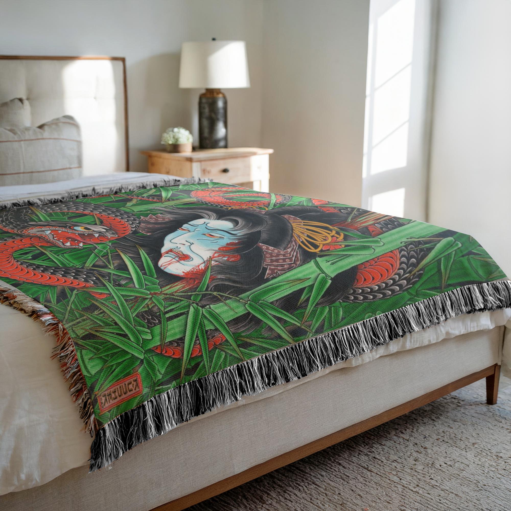 Close-up of snake and Namakubi design on woven decorative blanket