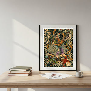 Framed artwork on a desk with books and a cup